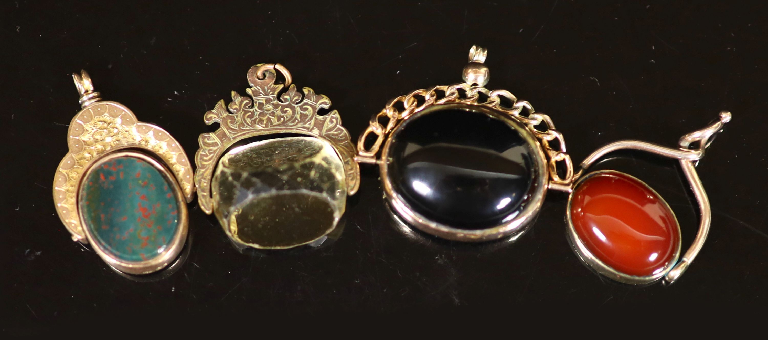 Four assorted gold and chalcedony set swivelling fob seals, three hallmarked for late 19th and early 20th century